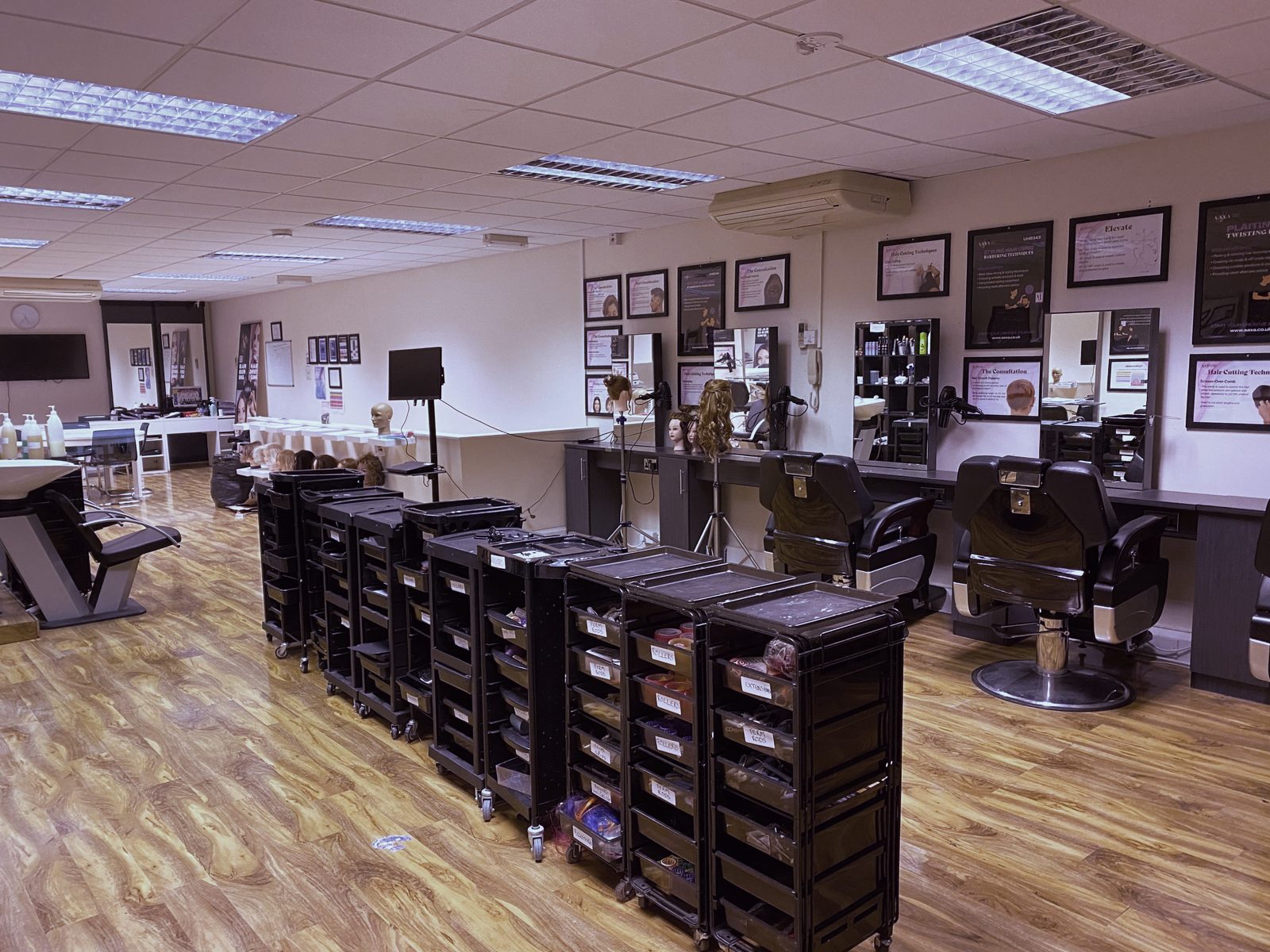 Rows of trolleys, styling stations and barber chairs at the Feltham hub